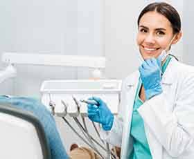 Dentist smiling at patient's dental exam