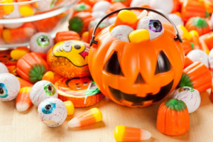 Close up of pumpkin bucket overflowing with Halloween candy